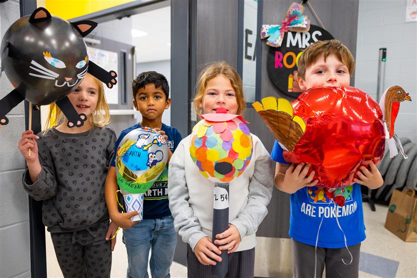 Students participate in a balloon parade